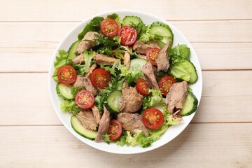 Delicious fresh tuna salad on white wooden table, top view