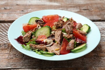 Delicious fresh tuna salad on wooden table, closeup