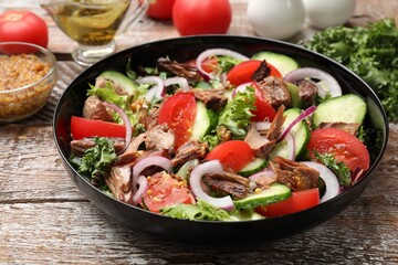 Delicious fresh tuna salad on wooden table, closeup