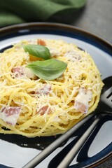 Plate with delicious pasta Carbonara on table, closeup