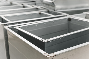 Ventilation rectangular ducts and pipeline parts on store outdoors.