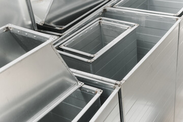 Ventilation rectangular ducts and pipeline parts on store outdoors.