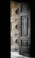 Light entering a dark room through a door in an ancient cathedral