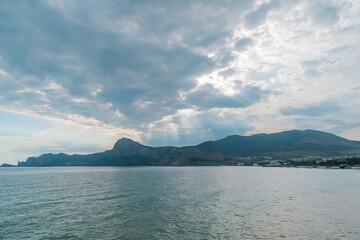 Sun's rays break through the clouds over the sea