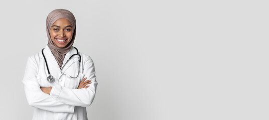 Medical Services For Muslim Women. Portrait Of Black Female Doctor In Hijab And White Coat Standing...