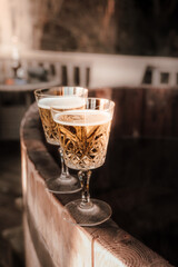 Two glasses of champagne , relaxing in hot tub.