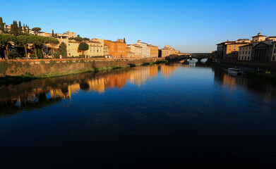 Golden Reflections on the Arno River, Florence
The warm glow of the setting sun reflects on the Arno River and the historic buildings along its banks, with the Ponte Vecchio visible in the distance.
