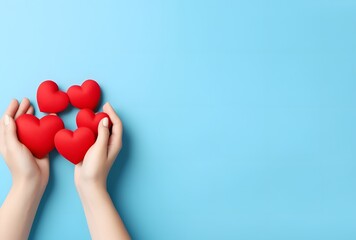 Fototapeta premium Valentine's Day Hearts in Hands on Blue Background