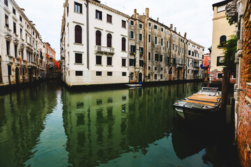 Venetian Canal Lined with Historic Buildings and Boats
A peaceful Venetian canal scene with historic architecture and a boat docked along the water.