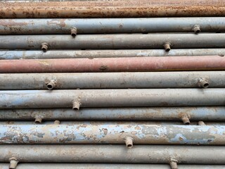 Scrap metal. Rusty old metal pipes lie in a row. Metal background 