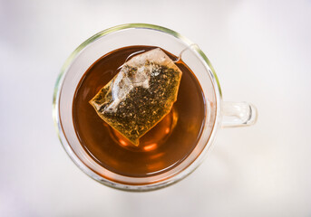 Black tea  with tea bag top view isolated