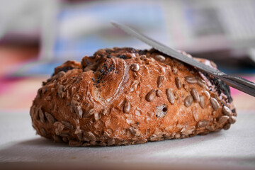 Whole meal bread roll isolated on breakfast table