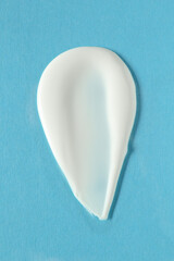 Smear of cosmetic product on light blue background, top view