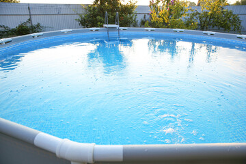 Above ground swimming pool in garden, closeup