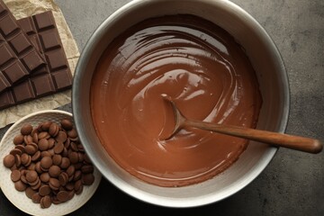 Chocolate dough in bowl and ingredients on grey table, flat lay