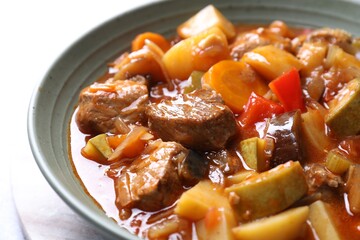 Delicious stew with vegetables in bowl on table, closeup