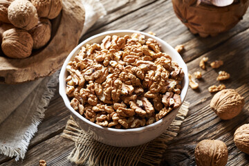 Shelled and whole walnuts on a table