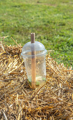 a discarded plastic cup with a lid from the drink