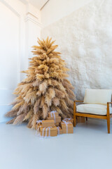 Obraz premium beige artificial spruce and a bench on a white wall background