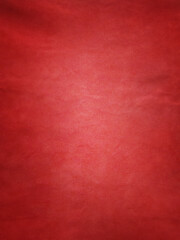 Red suede texture vertical photo size. Vignette on red material.