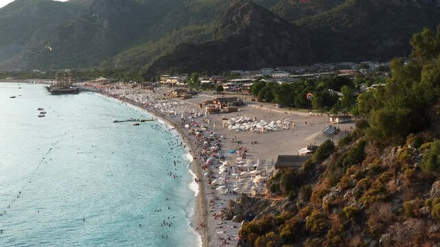 Panoramic view of Oludeniz from the Butterfly Valley road with paragliders. Zoom to Ooludeniz beach.