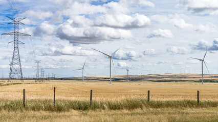 Wind power towers and power line on  agricultural field  at fall season