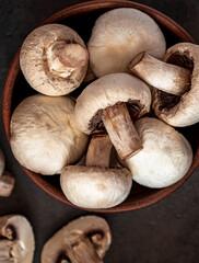 Raw peeled champignon mushrooms in a plate