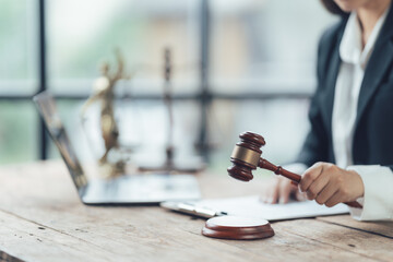 Justice Served: A female lawyer, poised and confident, holds a gavel in her hand, ready to deliver a verdict. The image evokes themes of authority, justice, and legal proceedings.