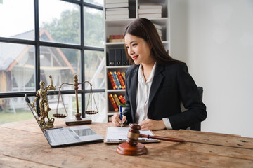 Focused and Determined: A confident female lawyer in a sleek suit, working diligently at her desk,...