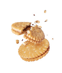 Two crispy delicious biscuits crushed into pieces in the air isolated on a white background