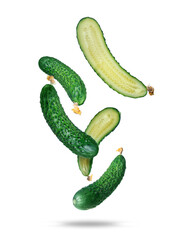 Ripe whole and cut cucumbers in the air isolated on a white background