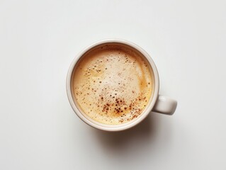 A top view of a coffee cup with a perfectly round foam on a white background