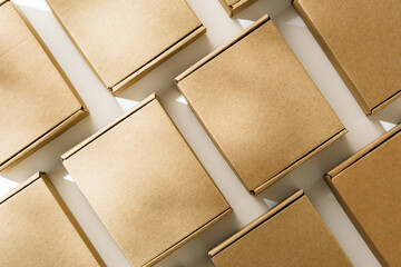 Brown cardboard boxes arranged on a neutral background in a warehouse setting during daylight hours