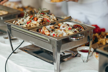 A close-up view of a chafing dish filled with meat