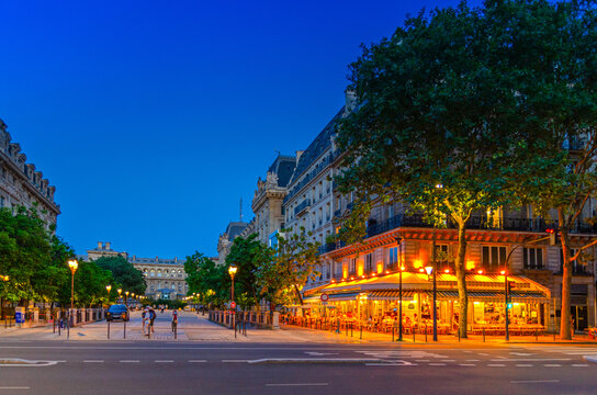 Paris city with street cafe restaurant lights in the evening, Paris cityscape twilight sunset view, traditional Parisian architecture on Place Louis-Lepine square in historic city center, France