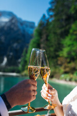 Naklejka premium A loving couple in a boat drinks champagne from glasses