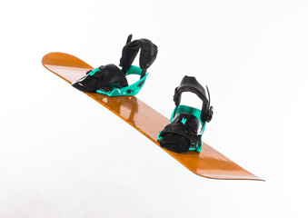 orange snowboard with boots isolated on white background