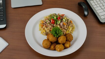 Plate of food on the desktop in the office