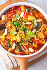 Minestrone soup with various vegetables and gnocchi Sarde pasta, the first   Italian dish for the winter and autumn period. Italian cuisine, Sardinian pasta, front view