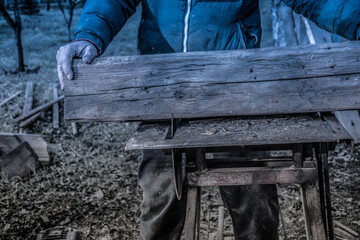 Carpenter's Hands Cutting Wood With Tablesaw