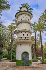 The dovecote tower in the Municipal Park of Elche. In the palm grove in elche, Valencian Community , Alicante, Spain