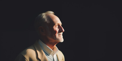 Elderly man smiling in profile, illuminated by soft sunlight, evoking a peaceful and joyful atmosphere