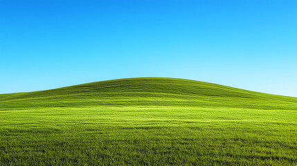 Obraz premium Lush green hill against clear blue sky