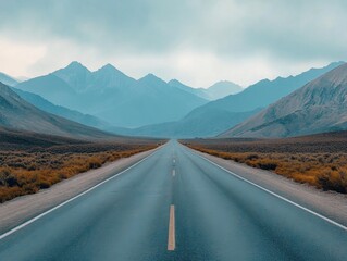 Winding road leading through misty mountain valley.