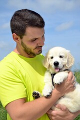 Portrait of a young man with his golden retriever puppy. Family moments. Sharing time with loved ones. No to animal abandonment. Pets. The dog is man's best friend.