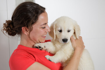 Portrait of a young woman with her golden retriever puppy. Family moments. Sharing time with loved ones. No to animal abandonment. Pets. The dog is man's best friend.