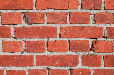 Close up photo of an old red brick wall.