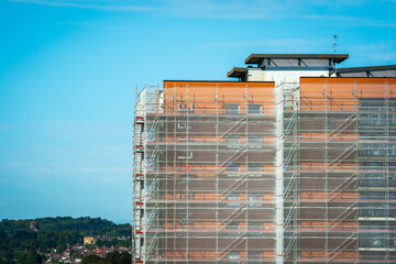 Scaffold sheeting net wrapped apartments building during insulation in england uk