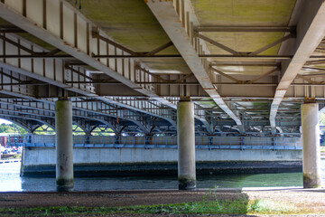 Motorway bridge in the UK, Image shows a bridge supporting the M27 over a river as traffic passes by on top on a cold Autumn day