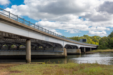Motorway bridge in the UK, Image shows a bridge supporting the M27 over a river as traffic passes by on top on a cold Autumn day